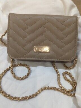 Stylish bebe Sophia wallet-on-chain crossbody bag in a taupe-gray color with che